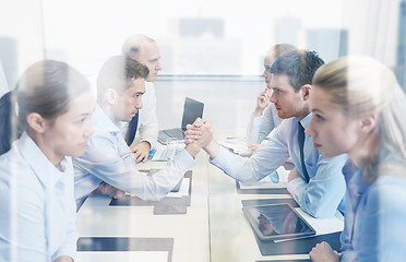 Image showing smiling business people having conflict in office