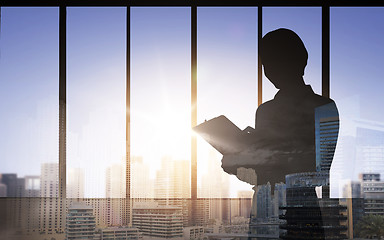 Image showing silhouette of woman with clipboard over city