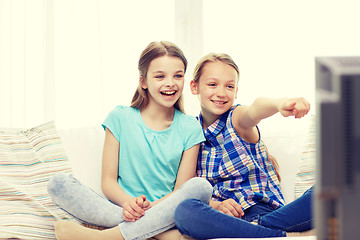 Image showing two happy little girls watching tv at home