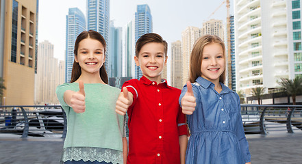 Image showing happy boy and girls showing thumbs up