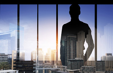 Image showing silhouette of business man over city background