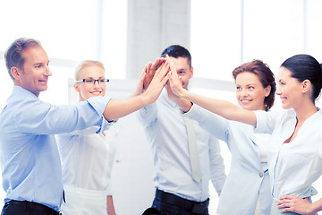 Image showing business team celebrating victory in office