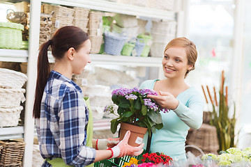 Image showing happy women choosing flowers in greenhouse