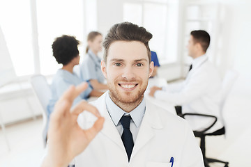 Image showing happy doctor over group of medics at hospital