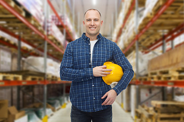 Image showing happy man with hardhat over warehouse