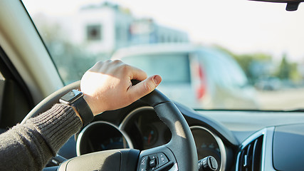 Image showing Close-up Of A Man Hands Holding Steering Wheel While Driving Car