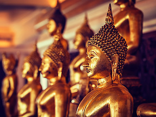 Image showing Golden Buddha statues in buddhist temple