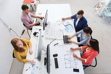 Image showing creative team with computers, blueprint at office