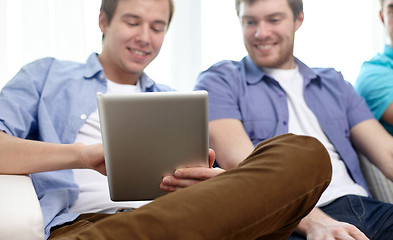 Image showing close up of happy friends with tablet pc at home