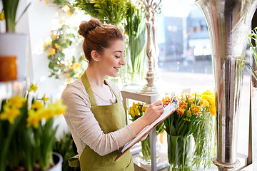 Image showing florist woman with clipboard at flower shop