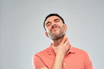 Image showing man touching neck and suffering from throat pain