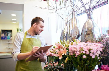 Image showing florist man with clipboard at flower shop