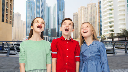 Image showing amazed boy and girls looking up