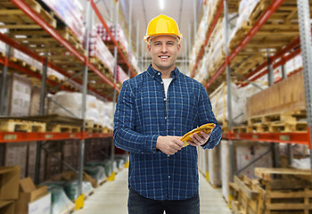 Image showing happy man in hardhat with gloves over warehouse