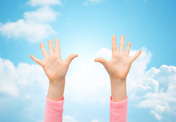 Image showing close up of little child hands raised upwards