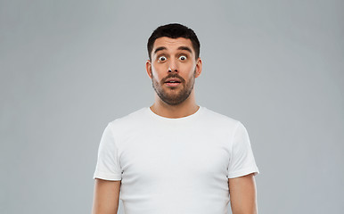 Image showing scared man in white t-shirt over gray background