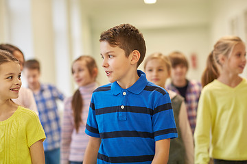 Image showing group of smiling school kids walking in corridor