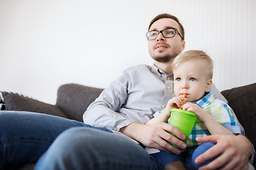 Image showing father and son drinking from cup and at home