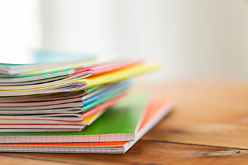 Image showing close up of notebooks on wooden table