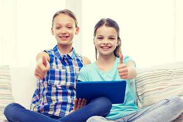 Image showing happy girls with tablet pc and showing thumbs up