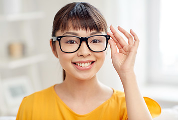 Image showing happy asian young woman in glasses at home