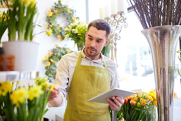 Image showing man with tablet pc computer at flower shop