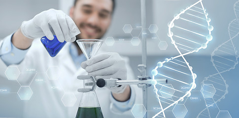 Image showing close up of scientist with test tubes and funnel