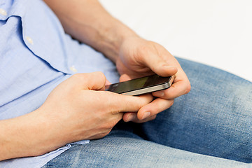 Image showing close up of man with smartphone at home