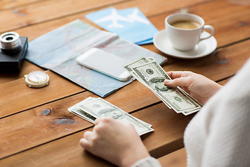 Image showing close up of traveler hands counting dollar money