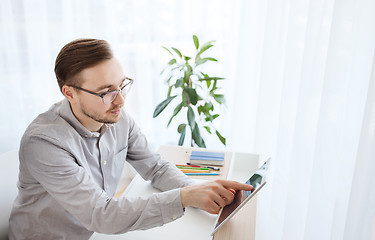 Image showing happy creative male office worker with tablet pc