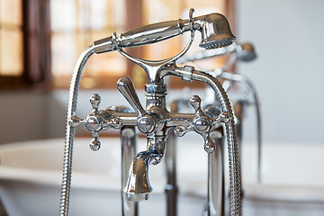 Image showing close up of bath tap and shower at bathroom