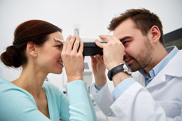 Image showing optician with pupilometer and patient at eye clinic