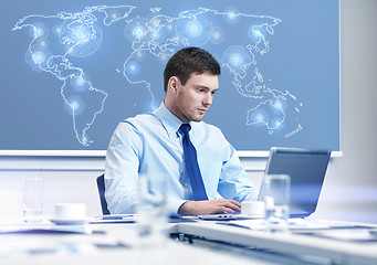 Image showing businessman with laptop working in office