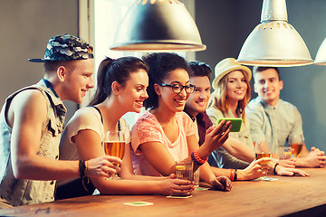 Image showing happy friends with smartphone taking selfie at bar