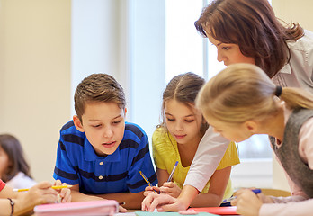 Image showing group of school kids writing test in classroom