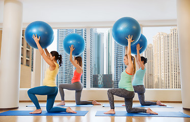 Image showing happy pregnant women exercising with ball in gym