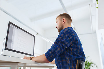 Image showing creative man or programmer with computer at office