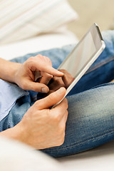 Image showing close up of man working with tablet pc at home