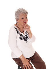 Image showing Senior woman with finger over mouth.