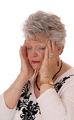Image showing Senior woman holding her head for headache.
