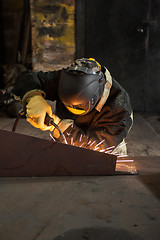 Image showing worker welding metal