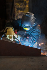 Image showing worker welding metal