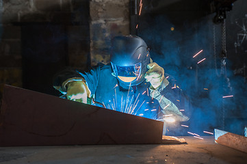 Image showing worker welding metal