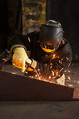 Image showing worker welding metal