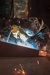 Image showing worker welding metal