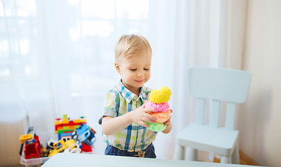 Image showing happy little baby boy with ball clay at home