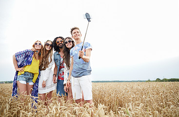 Image showing hippie friends with smartphone on selfie stick