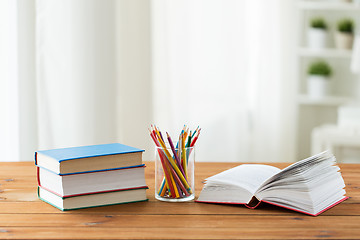 Image showing close up of crayons or color pencils and books