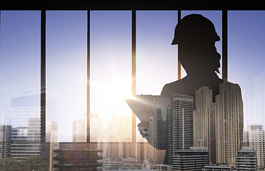 Image showing silhouette of woman in helmet with clipboard