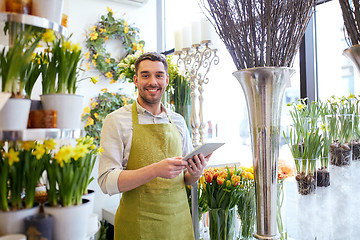 Image showing man with tablet pc computer at flower shop